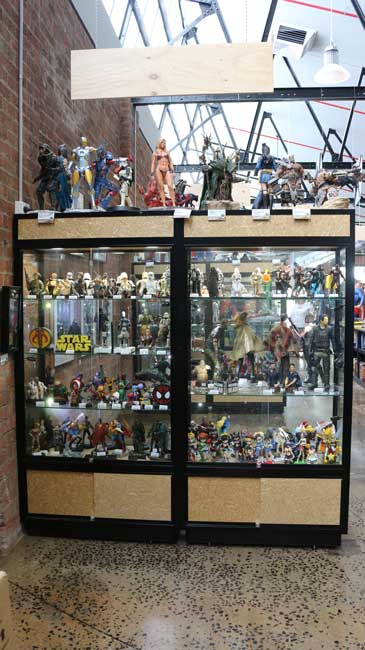 upright collectibles cabinet with super  heroes at pop culture
