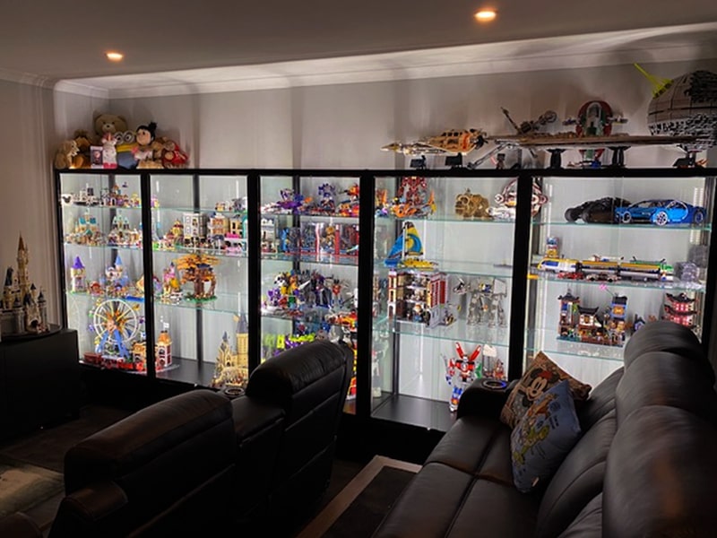 Jason and Laura’s collection housed in a Showfront Lego display cabinet in their home theatre room. 