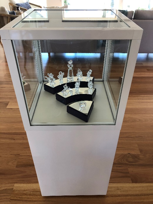 Austin's Swarovski figurine display case is a Showfront CBDL pedestal cube.